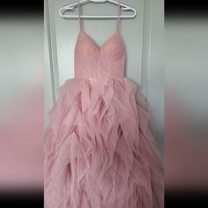 a pink dress hanging on a hanger