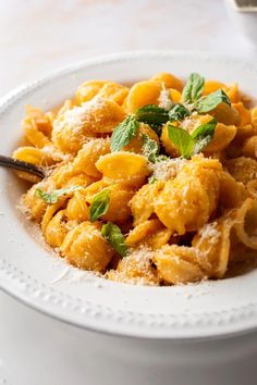 a white bowl filled with pasta and sauce