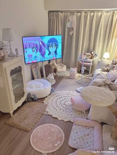 a living room filled with lots of furniture and a flat screen tv mounted on the wall