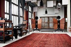 a room filled with lots of different types of furniture and decor on top of a red rug