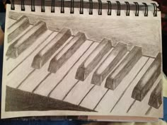 a drawing of piano keys on a sheet of paper with colored pencils in it