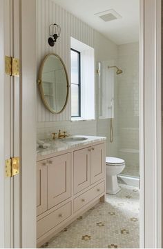 a bathroom with a sink, mirror and toilet in it's center piece is shown