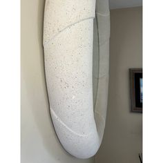 a white surfboard hanging on the wall