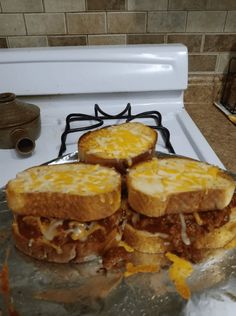 three sandwiches are stacked on top of each other in front of an oven with the door open