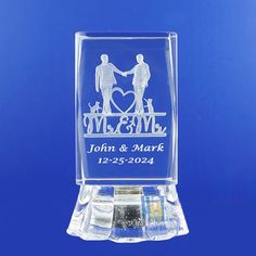 a clear acrylic block with two people holding hands and the words mr & mrs engraved on it