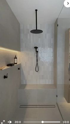 a bathroom with a shower, sink and mirror in it's center area is shown