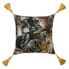 a cushion with leopards and tropical leaves on it