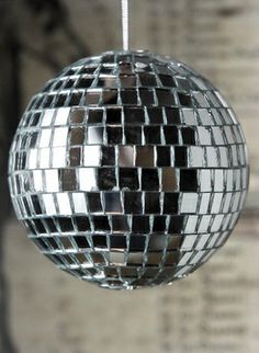 a shiny disco ball hanging from a string