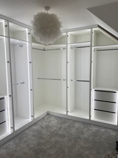 an empty room with white closets and lights