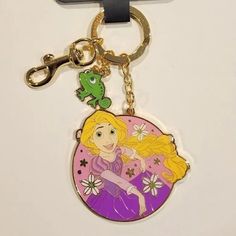 there is a keychain with a princess and frog on it's side