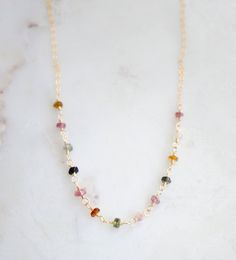 Bring some color and joy into your life with natural Tourmaline gemstones! Known to spark inspiration and happiness, this crystal is believed to build self-confidence and reduce fear. It's also thought to balance yin-yang energies and aid in detoxification. Plus, it's the perfect birthstone gift for those born in October.Our handcrafted necklace features genuine, faceted Tourmaline stones in a variety of colors (black, green, brown, and pink). Each necklace is unique with its own color pattern, Adjustable Tourmaline Gemstone Necklace, Spiritual Tourmaline Gemstone Bead Necklaces, Spiritual Tourmaline Gemstone Bead Necklace, Tourmaline Birthstone Jewelry, Tourmaline Gemstone Beaded Necklace For Gift, Healing Tourmaline Gemstone Bead Necklaces, Multicolor Spiritual Necklace For Everyday Wear, Everyday Spiritual Wire Wrapped Necklaces, Spiritual Multicolor Necklaces For Everyday Wear