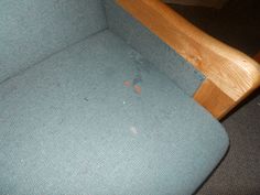 an upholstered chair is shown with rust on the seat