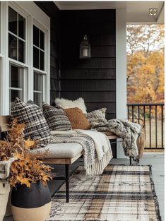 a couch sitting on top of a wooden porch