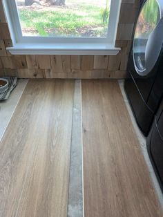 a washer and dryer sitting in front of a window