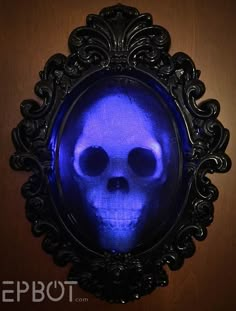 a blue skull in a black frame on a wall