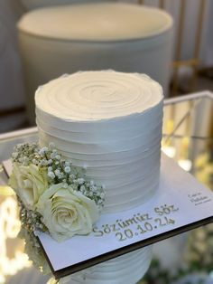 a white wedding cake with flowers on top