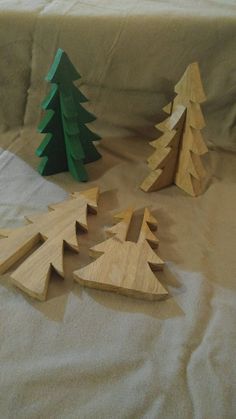 several wooden christmas trees on a table