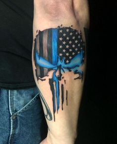 a man's arm with a blue skull and american flag tattoo design on it