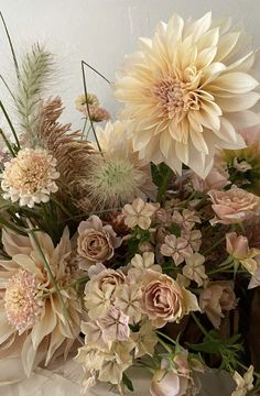 a vase filled with lots of different types of flowers