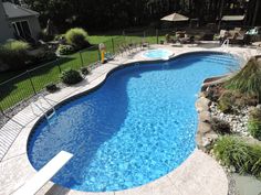 an above ground swimming pool surrounded by landscaping