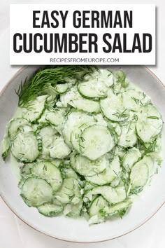 a bowl filled with cucumber salad on top of a white table