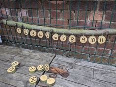 the numbers are written on wooden discs in front of a fence