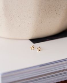 This exquisite 14k gold stud earring features a delicate flower design and a sparkling diamond stone. Its versatility allows for effortless pairing with any stud earrings in your collection. You can even wear it in the shower or while swimming, making it perfect for everyday wear. 5mm Flower Stud Earring with Diamonds Available in 14k Yellow Gold, White gold and Rose Gold. 1 Pair / 14k solid gold posts and backings Dainty Gold Cluster Earrings In Sterling Silver, Dainty 14k Gold Cluster Earrings, Dainty Gold Cluster Earrings, Minimalist Cluster Earrings As Gift, Dainty Gold Hypoallergenic Cluster Earrings, Dainty Gold Cluster Earrings Hypoallergenic, Dainty Hypoallergenic Gold Cluster Earrings, Minimalist Gold Cluster Earrings As A Gift, Sparkling Diamond