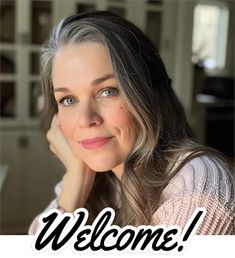 a woman with grey hair is smiling for the camera