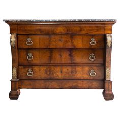 an antique chest of drawers with marble top and brass hardware on the bottom, against a white background