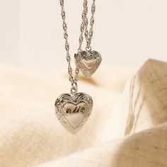 Our Engraved Heart Locket can be engraved with initials, words, or short messages for the perfect gift for your loved ones! Materials & Finish: * High Quality 316L Stainless Steel * 18k Gold, Silver We use a THICK PLATING for a piece that will be in your jewelry box for years to come! Size Specs: * Small Heart Locket Pendant: 13mm * Big Heart Locket Pendant: 20 mm HOW TO ORDER * Select your Chain type & Length * Select your Engraving Options * Tell us all your item details in the personalization Mother's Day Double Heart Engraved Locket Necklace, Engraved Heart Pendant Locket For Personalized Gift, Vintage Engraved Heart Necklace For Mother's Day, Silver Charm Necklace For Valentine's Day Keepsake, Vintage Style Engraved Heart Necklace For Mother's Day, Silver Heart Necklace With Engraving Option For Anniversary, Valentine's Day Engraved Heart Necklace Keepsake, Silver Double Heart Locket Necklace, Personalized White Gold Locket Necklace For Gift