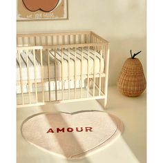 a baby's room with a heart shaped rug in the shape of an apple