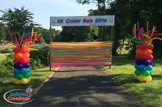 an entrance decorated with balloons and streamers for a 5k color run 2016 event