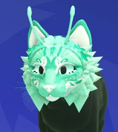 a cat wearing a green costume with spikes on it's head and eyes, standing in front of a blue background