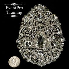 the brooch is next to a dime on a black background with an eventpro training logo