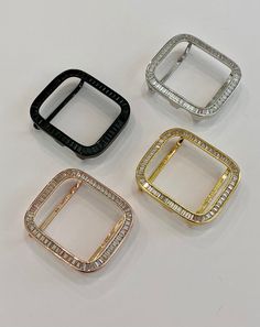 Add some luxury to your Apple Watch with our Lab Diamond Apple Watch Case with Baguette Bezel. This custom-designed case features three rows of high-quality lab diamond large baguettes set in 14k gold plating. Available in sizes 38mm, 40mm, 41mm, 42mm, 44mm, and 45mm for Apple Watch Series 2-9 SE, this designer cover comes in silver, rose gold, yellow gold with clear stones, and black rhodium with black lab diamonds. Its two bars on the back ensure a secure fit while allowing access to all butto Diamond Apple Watch, Iphone Watch, Apple Watch Series 2, Iwatch Apple, Apple Watch Case, Black Lab, Clear Stone, Black Rhodium, Baguette Diamond