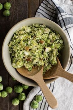 brussel sprouts in a bowl with a wooden spoon on the side