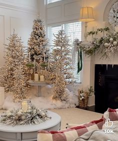 a living room decorated for christmas with white and silver decorations