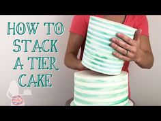 a woman holding a cake with the words how to stack a tier cake on it