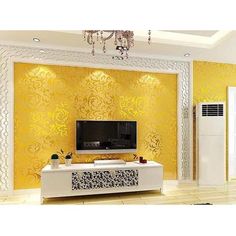 a living room with yellow wallpaper and a white tv on top of a stand