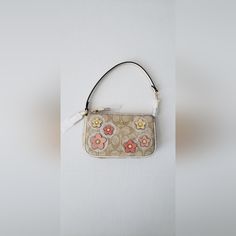 Coach Nolita 19 In Signature Canvas With Floral Applique Color: Gold/Light Khaki Multi Product Details Signature Coated Canvas And Smooth Leather Two Credit Card Slots Inside Multifunction Pocket Zip-Top Closure, Fabric Lining Chain Handle With 6 1/4" Drop 7 1/2" (L) X 4 1/2" (H) X 2" (W) Comes From A Non-Smoking Home, Pet Free. Please Note That The Measurements Of The Item Will Be Approximate Sizes. Color Of The Item Might Be Slightly Different Due To The Light Reflection Of The Camera. Coach Nolita 19, Coach Nolita, Nolita 19, Coin Logo, Purple Clutch, Coach Clutch, Black Wristlet, Signature Canvas, Logo Collection