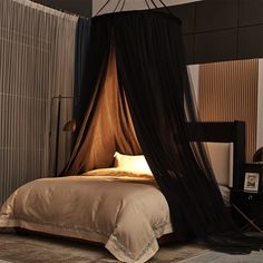 a bed with a canopy over it in a room