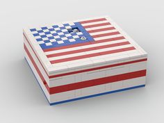 an american flag made out of legos on a white surface with blue and red stripes