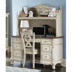 an antique white desk and chair in a room