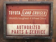 a sign on the side of a building that says toyota land cruiser world's toughest 4 wheel drive authorized parts & service