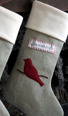 a christmas stocking with a red bird on the front and back of it's stockings