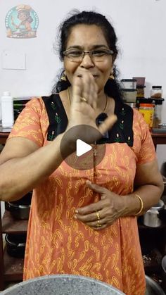 a woman is making something with her hands