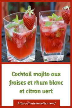 a close up of a drink in a glass on a table with a strawberries garnish