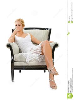 a woman sitting in a chair with her legs crossed