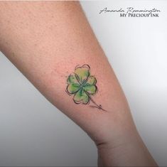 a four leaf clover tattoo on the arm