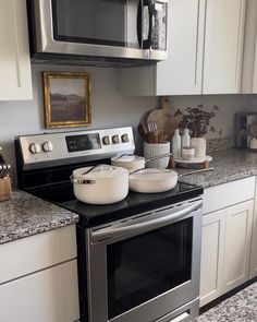 a stove top oven sitting inside of a kitchen next to a microwave above a counter